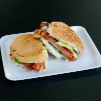 Torta de Jamon · Ham, cheese, mayonnaise, lettuce, tomatoes, red onions, avocado, and chipotle sauce.