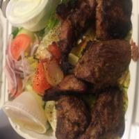 Lamb Shish Platter · Seasoned lamb chunks skewered and grilled to perfection. Served with rice, salad, grilled ve...