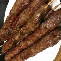 Kofta (Adana) · New! Homemade seasoned ground beef served with basmati rice, salad, grilled vegetables and p...