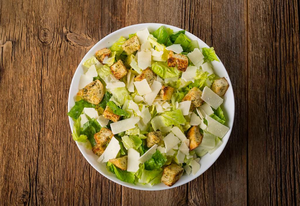 Caesar Salad · Crisp Romaine lettuce hearts, toasted garlic croutons, and shaved Asiago cheese.