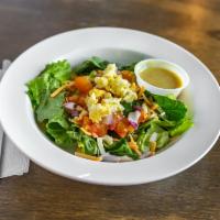 House Salad · Romaine lettuce topped with cheddar jack, tomatoes, onions, and egg.