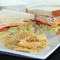 On The Avenue Turkey · Roast Turkey, cheddar cheese, deli mustard, mayo, lettuce, tomatoes, red onions, on soft whi...