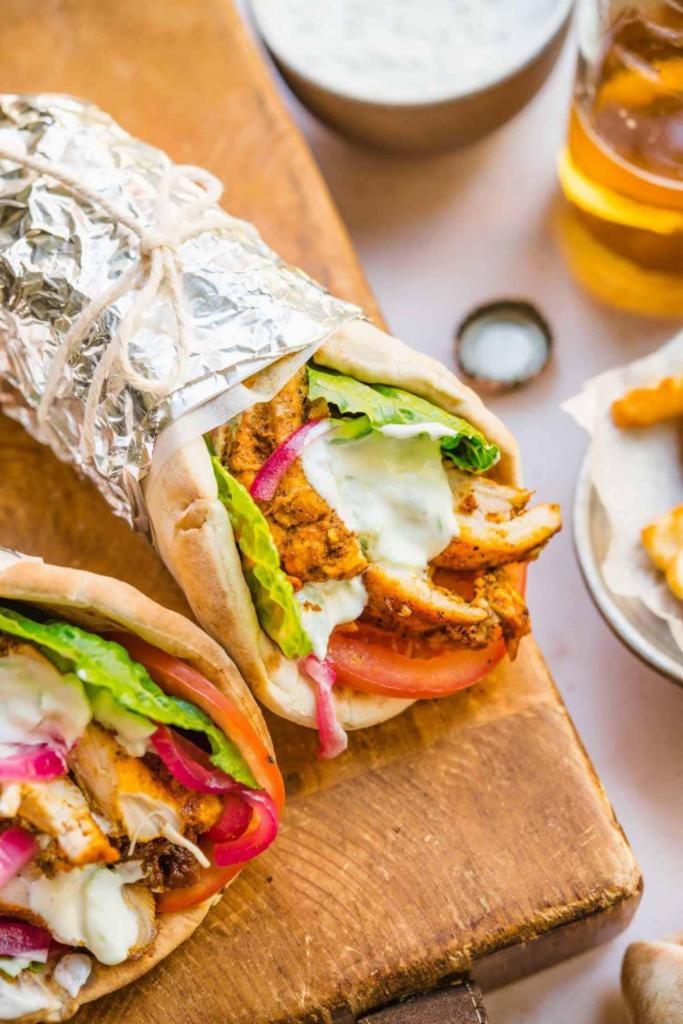 Shawarma Wrap · Grilled marinated chicken strips served over lettuce with tomatoes, tahini sauce and garlic sauce.