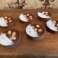 Chocolate Hazelnut Tart · Valrhona chocolate tart shell filled with a rich brownie hazelnut.