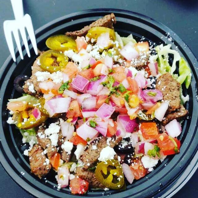 Taco Bowl · Steak or chicken over a bed of rice, served with beans, olives, pico de gallo, cheese, lettuce and crema