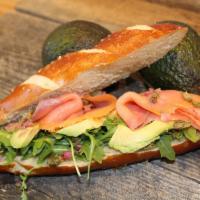 Nordic Sandwich · On pretzel bun, arugula, avocado, capers, lemon oil and smoked salmon.