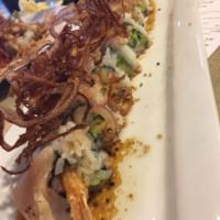 Tutu Roll · Crab, shrimp tempura, avocado and cucumber inside. Topped with albacore, spicy ponzu and cri...