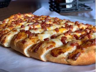 Make'em Flying Pie Pepperonisticks · Topped off with melted cheese and loaded with diced pepperoni!