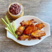 Chicken Wings · 8 lemongrass chicken wings served with khaosan sauce.