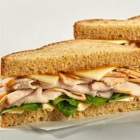 Classic Turkey Sandwich · Oven roasted turkey, sharp cheddar, little gem lettuce, honey mustard and house mayo on whol...