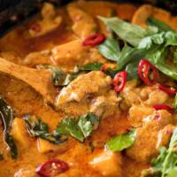 Red Curry · Red Curry paste cooked with coconut milk with bamboo shoots, bell pepper and fresh Thai basil.