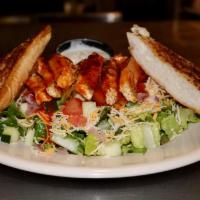 Grilled Buffalo Chicken Salad · Grilled chicken tossed in Buffalo, romaine, tomatoes, cucumber, red onion, shredded cheddar,...