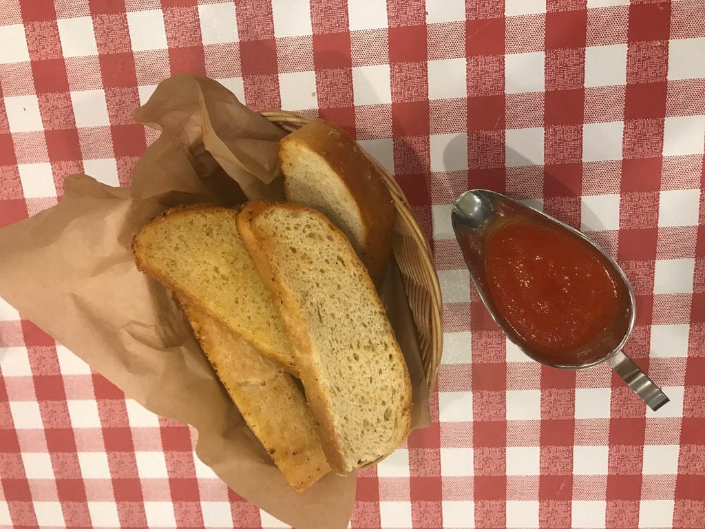 Garlic Bread · 5 pieces of our home made Italian garlic bread served with a side of our tomato sauce for dipping.