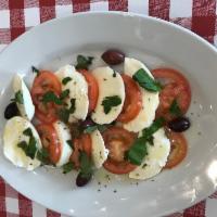 Mozzarella Caprese · Vine-ripened tomatoes and fresh mozzarella drizzled with extra-virgin olive oil and fresh ba...