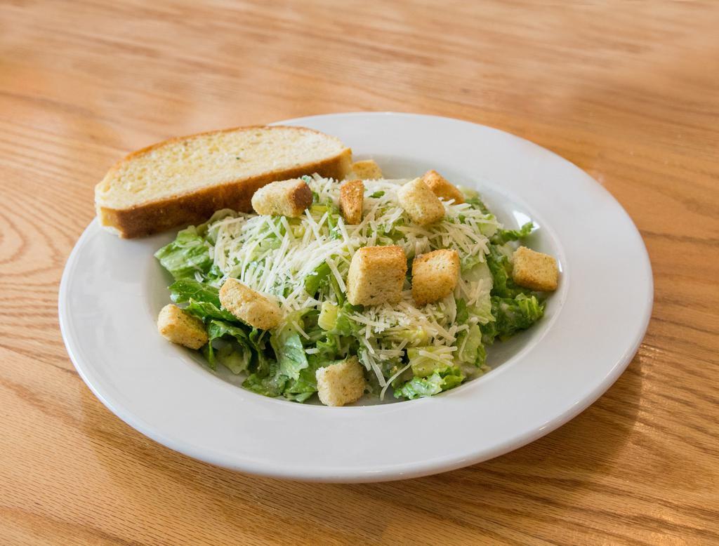 Caesar Salad · Fresh, crisp romaine, lettuce tossed with our Caesar salad dressing and croutons, topped with Parmesan cheese. Served with our homemade Italian garlic bread.
