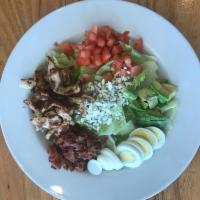 Cobb Salad · Romaine and iceberg lettuce topped with bacon, avocado, chicken, diced tomatoes, sliced egg,...
