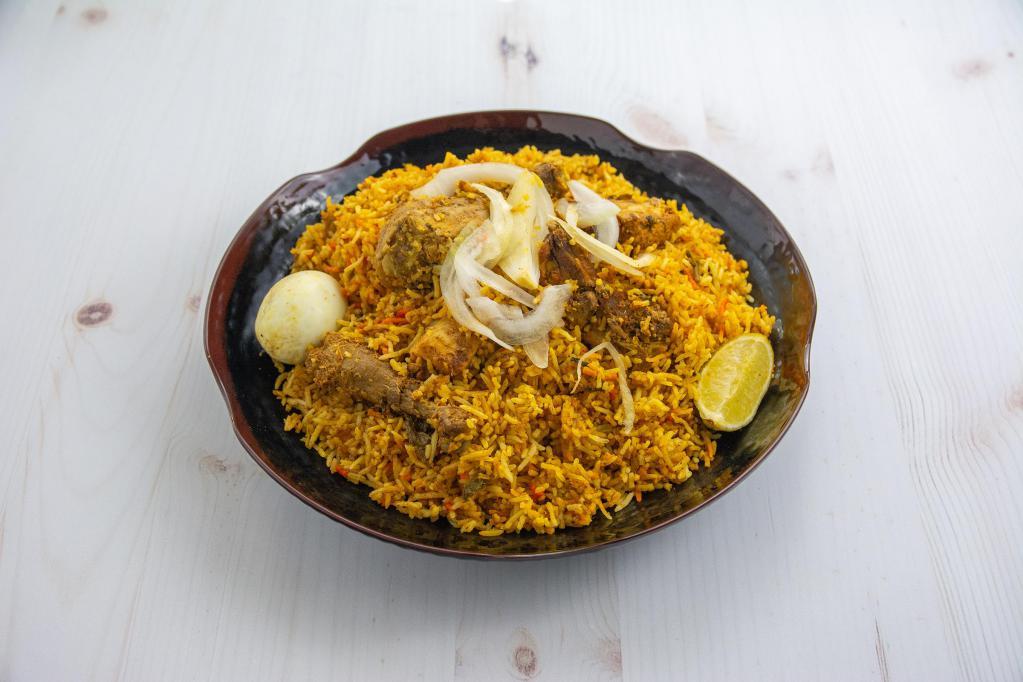 Chicken Dum Biryani · Long grain basmati rice cooked with saffron and spices. 