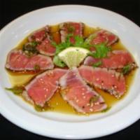 Tuna Tataki · Peppered, crusted tuna with ponzu sauce and scallions.