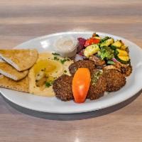 Falafel Pita Sandwich · Garbanzo beans with fresh herbs and spices, served with tahini. Vegetarian.
