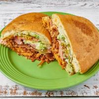 Torta Cubana · Meat-lover's sandwich with breaded beef, sausage, ham, chicken, and Mexican sausage. Topped ...