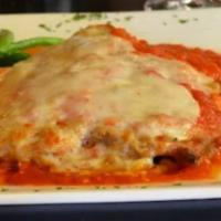 Chicken Parmigiana · Breaded cutlet topped with tomato sauce and melted cheese.