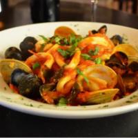 Zuppe di Pesce · Clams, mussels, scallops, shrimps, calamari over linguine white or red.