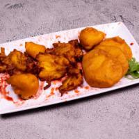Pakora · Mixed vegetable fritters, fried, and delicately spiced.