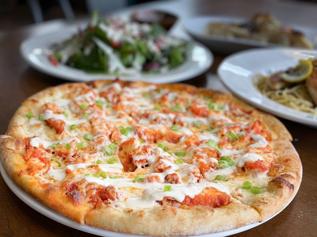 Buffalo Chicken Pizza · Mozzarella cheese, crumbled blue cheese, green onions, fried chicken tossed in Buffalo sauce and ranch drizzle.