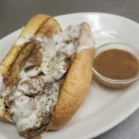 Italian Beef Sandwich · House specialty. Served with fries on a toasted french roll with house-made au jus on the si...