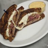 Classic Rueben Sandwich · Served with fries or coleslaw, on grilled rye bread with lean corned beef, sauerkraut, Swils...