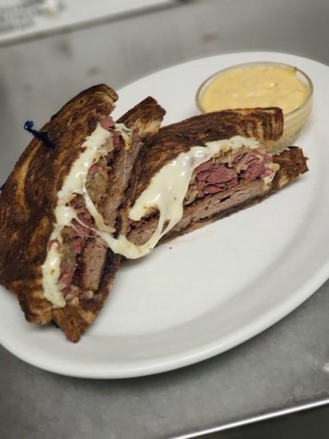 Classic Rueben Sandwich · Served with fries or coleslaw, on grilled rye bread with lean corned beef, sauerkraut, Swilss cheese, and Thousand Island dressing.