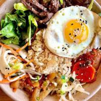 Bi Bim Bop Bowl · Our take on the Korean favorite. A fried rice ball on a bed of chopped Romain hearts surroun...