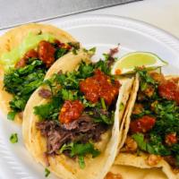 Barbacoa Taco · Steamed beef taco topped with cilantro and onions.
