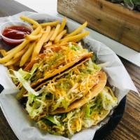 Crunchy Tacos · Hard taco shell filled with ground beef, topped with cheese and lettuce.