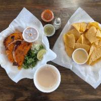 Chips & Queso  · Fresh tortilla chips served with a 4oz side of queso 