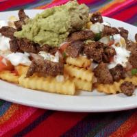Carne Asada Fries · Fries with steak, guacamole, sour cream, pico de gallo and cheese on top.