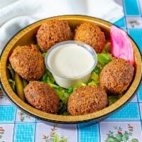Falafel pieces · Chickpeas mixed with fresh herbs and spices. Vegan, gluten free. Come with tahini dipping sa...