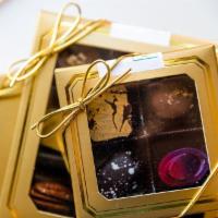 Signature Truffle Assortment (4 pieces) · A box of our signature truffles. Available in milk, dark, or an assortment of both.