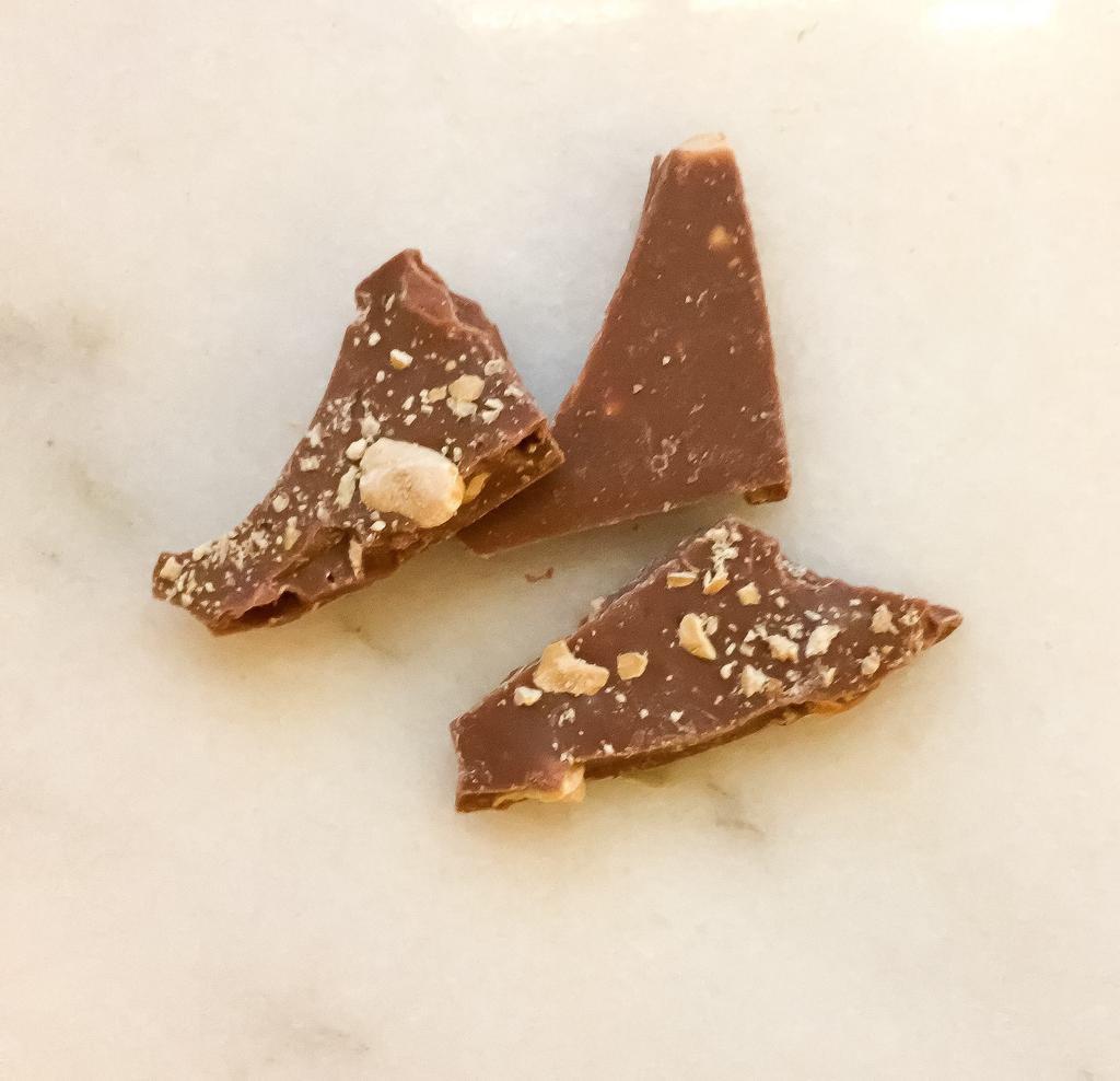 Milk Chocolate Hazelnut Bark · Top notes of caramel and brown sugar showcase a nutty butterscotch finish reminiscent of the classic sandwich spread. Note: contains tree nuts, milk, and soy.

35% cocoa milk chocolate with savory hand-roasted hazelnuts.