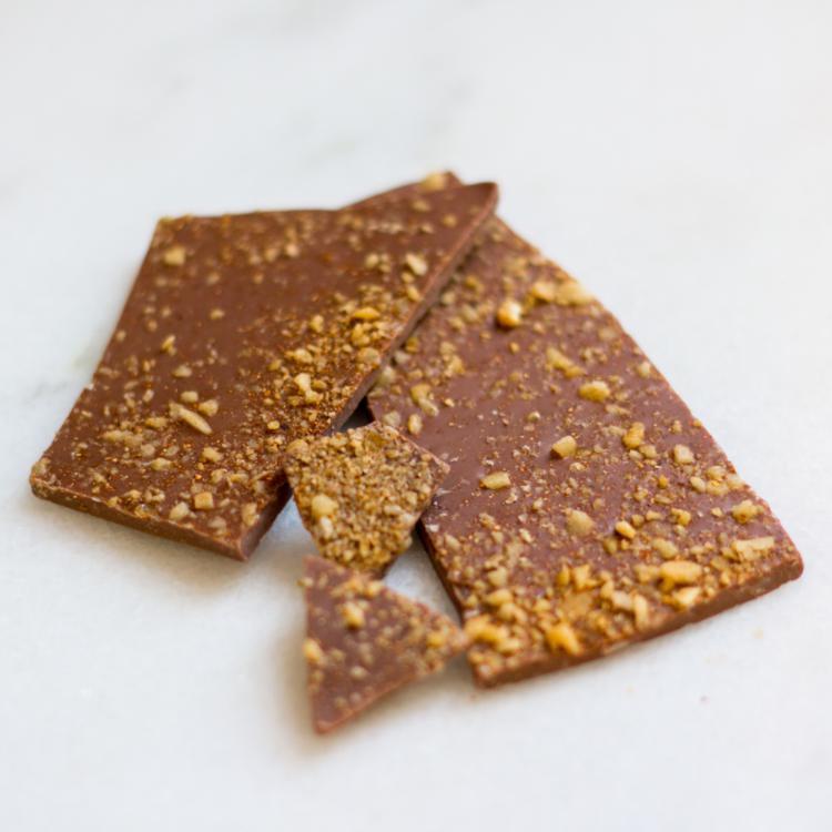 Milk Chocolate Firework Bark · Popping candy reacts with creamy milk chocolate and finishes with a touch of smoky heat. Note: contains milk and soy.

35% milk chocolate with Chipotle chili powder and popping candy.