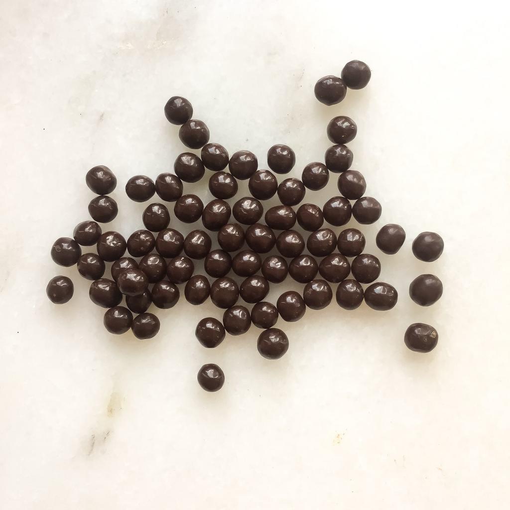 Dark Crunchy Pearls · Toasted puffed cereal enrobed in 55% dark chocolate. Note: contains wheat.