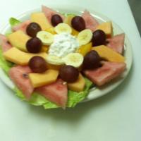 Fresh Fruit Salad Bowl · A heaping scoop of cottage cheese served with fresh fruit on a bed of lettuce with raisin br...