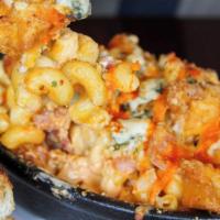 The Buffalo Blue Mac · Bowl of traditional gooey mac and cheese, topped with spicy Buffalo chicken breast, blue che...