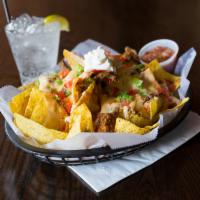 Southewest Nachos · Fresh fried tortilla chips loaded with chili, pulled pork, white queso, tomatoes, green onio...