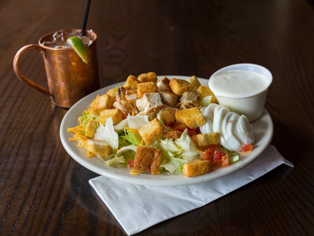 Grilled Chicken Salad · Leafy greens, cheddar, tomatoes, hard boiled egg, 2 crispy chicken strips and croutons.