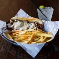 Pot Roast Sandwich · Tender pork roast piled high on a  hoagie, topped with melted provolone cheese and drizzled ...