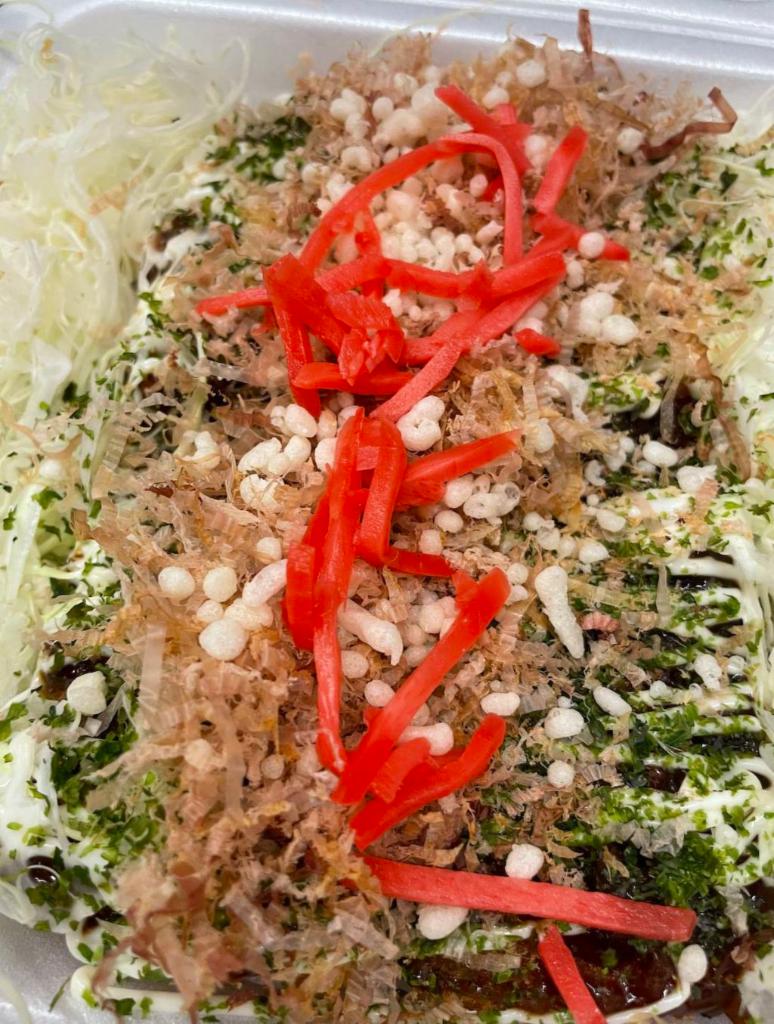 Ramen Katsu Okonomiyaki · Ramen katsu okonomiyaki includes a thin layer of 100% kurobuta slices, ramen noodles, and okonomiyaki toppings.