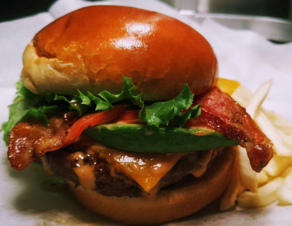Crazy Club Burger · ½ lb. beef burger, bacon, cheddar, avocado, lettuce, and tomatoes on brioche.