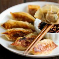 Dumplings 饺子 · With house made sauce. Add sauces for an additional charge.