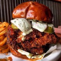 Nashville Hot Katsu Sandwich · Nashville hot chicken, 'Bama white sauce, pickles, greens, and radish on a pretzel bun.